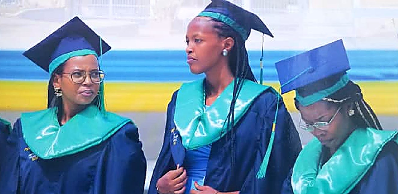St Bernard's International University graduands in navy and teal academic gowns
